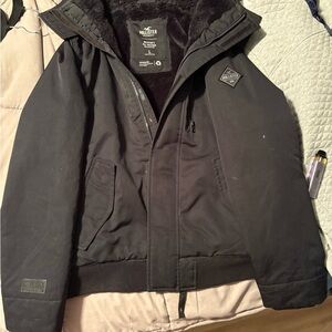 Black Hooded Bomber Jacket by Hollister with Double Closure and Textured Finish
